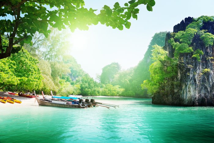 Tropical island with boats and kayaks