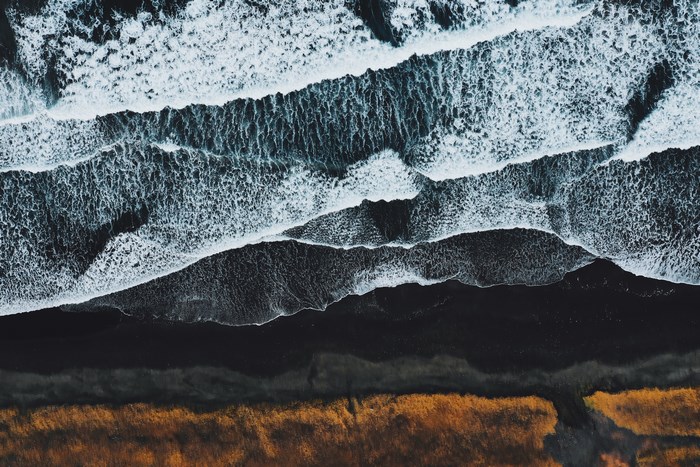 Aerial View of Waves Crashing on Black Sand Beach in Iceland