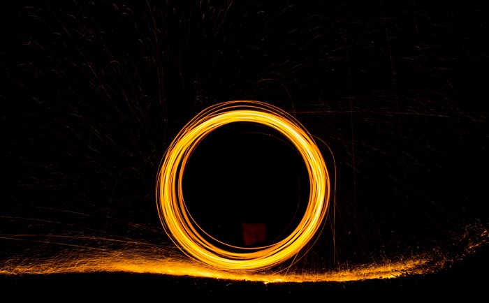 Circular light trail from steel wool spinning in the dark