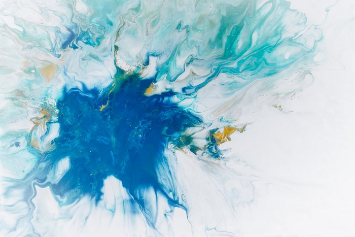 Abstract acrylic paint splash with blue, cyan, and gold colors