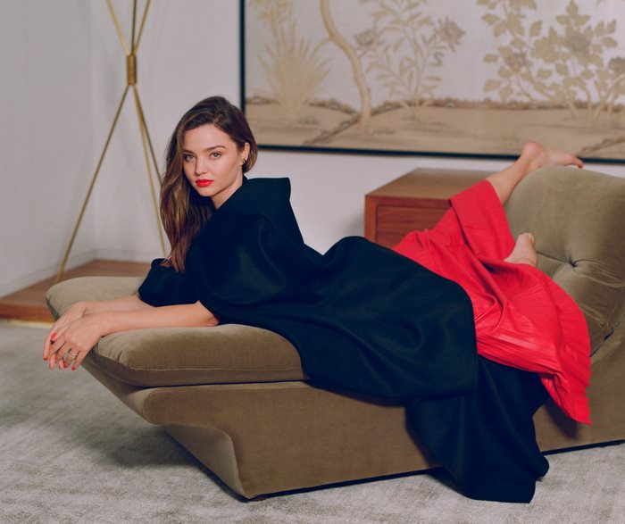 Miranda Kerr posing on a couch