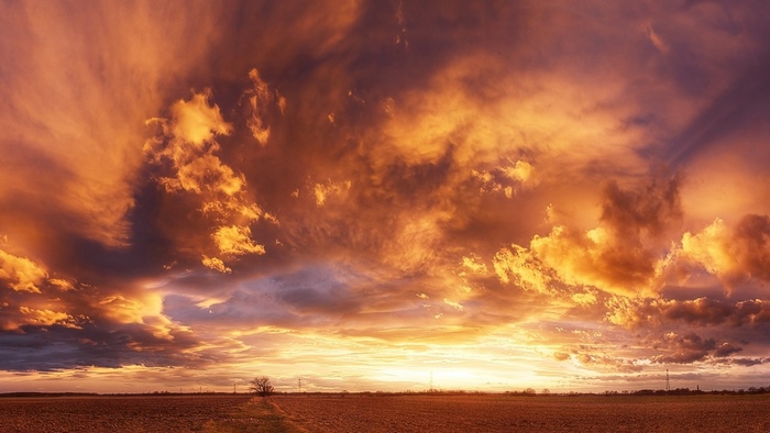 Dramatic sunset over a harvested field