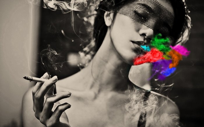 Woman smoking with colorful smoke