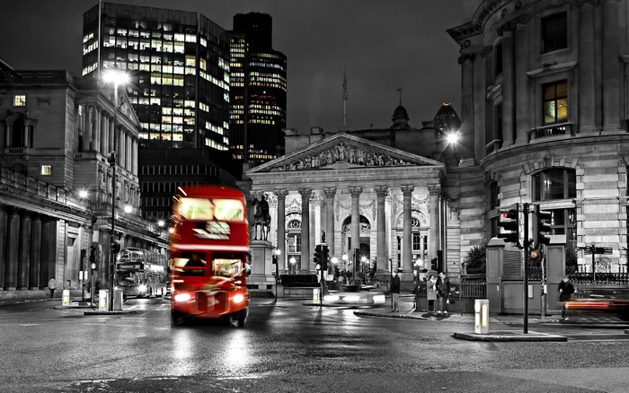 Red double-decker bus in London at night