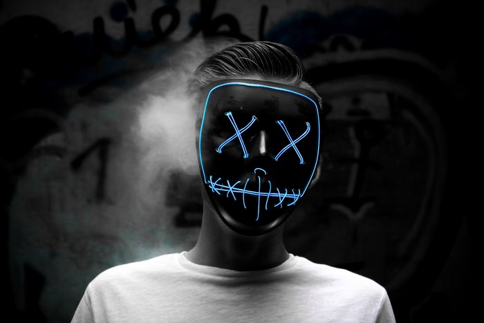 Man wearing a blue LED purge mask
