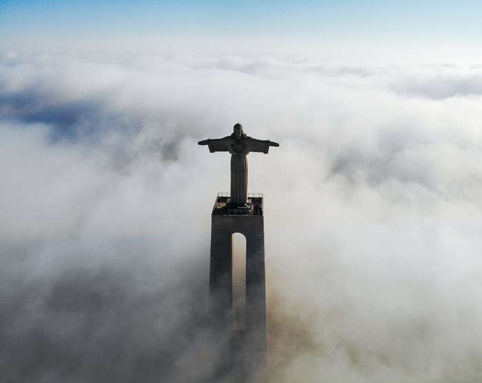 Christ the King statue above clouds