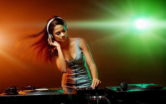 DJ girl with headphones playing music on turntables