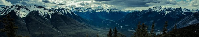 Panoramic view of snow-capped mountains and a valley