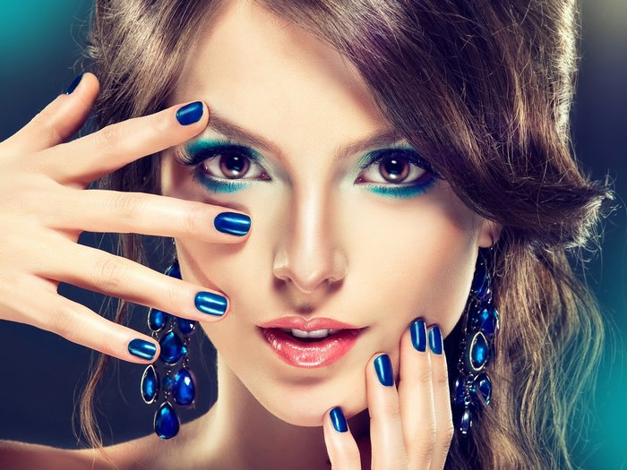 Woman with blue makeup and nails
