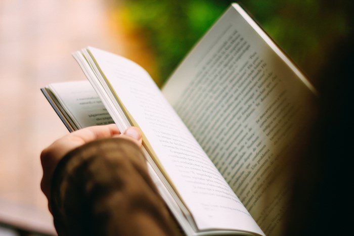 Person reading an open book