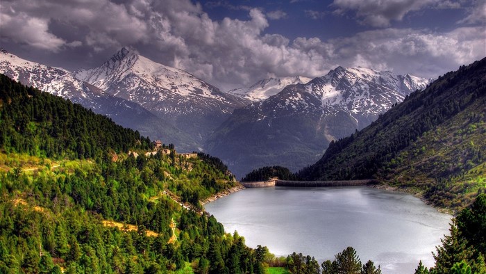 Lake and snow-capped mountains with forest