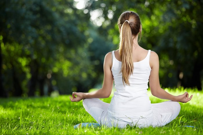 Woman Meditating Outdoors in Peaceful Yoga Pose