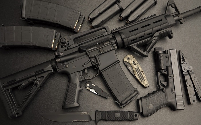 AR-15 rifle, pistol, knives, and magazines