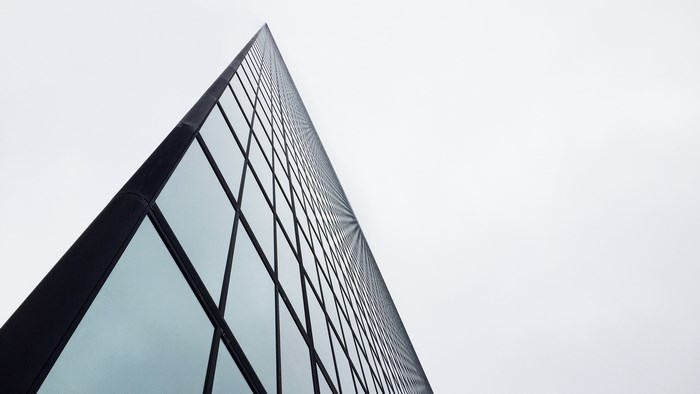 Minimalist skyscraper with glass windows and geometric lines