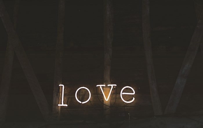 Neon love sign in a dark wooden building