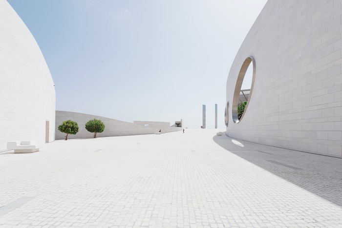 Minimalist white architecture with trees and sky