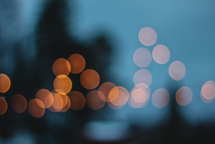 Orange and white bokeh lights against blue background