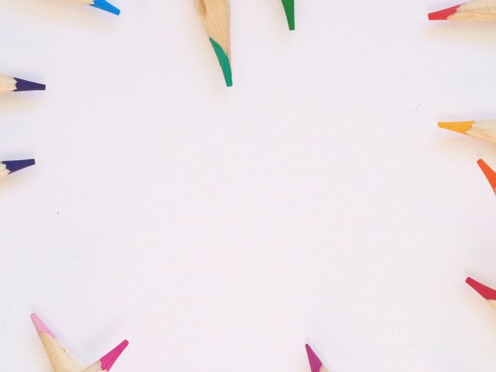 Colored pencils arranged on a white background