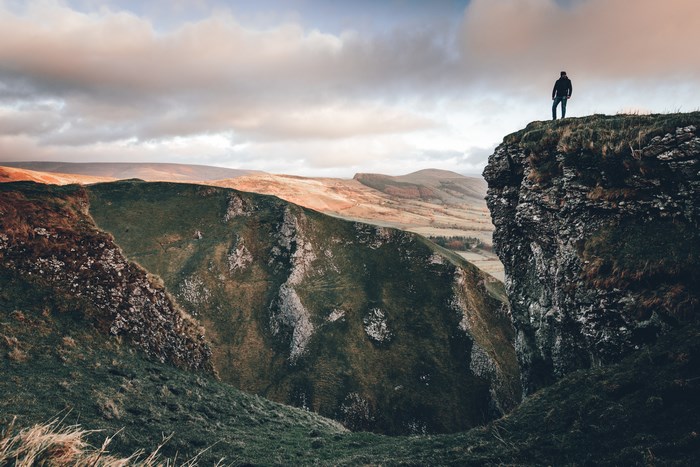 Man standing on a cliff edge in the Peak District