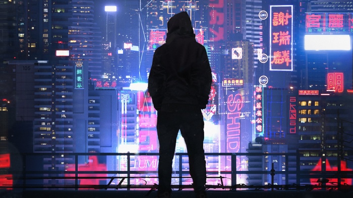 Hooded figure overlooking a futuristic city