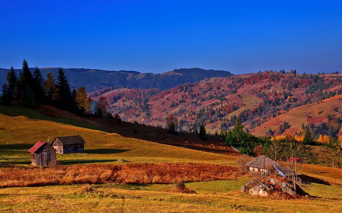 Autumn mountain landscape with wooden cabins