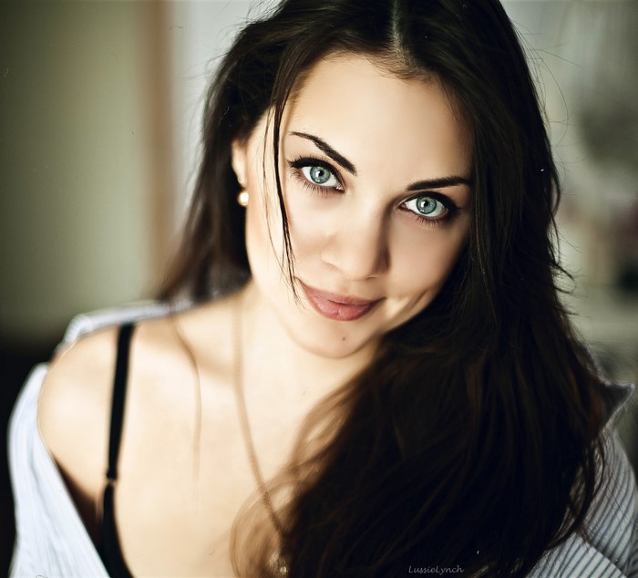 Close-up of a woman with blue eyes and dark hair