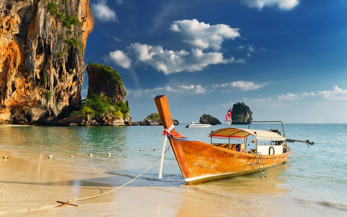 Tranquil Beach with Traditional Wooden Boat