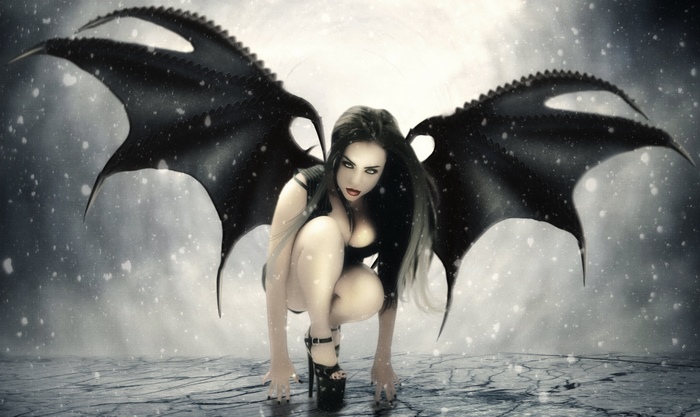 Gothic demon girl with black wings in snow