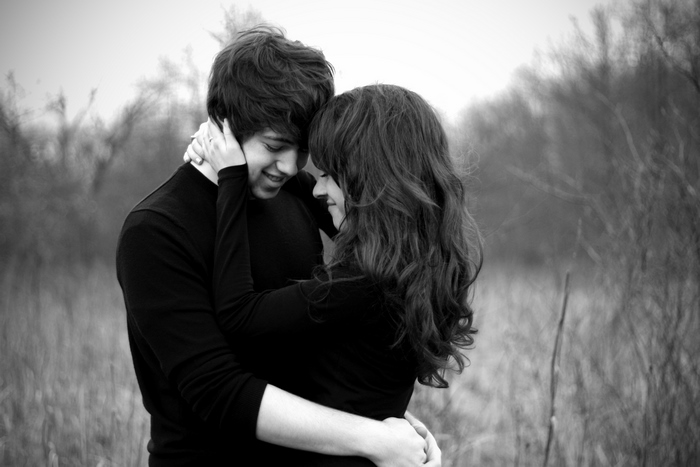 Couple hugging outdoors in black clothing