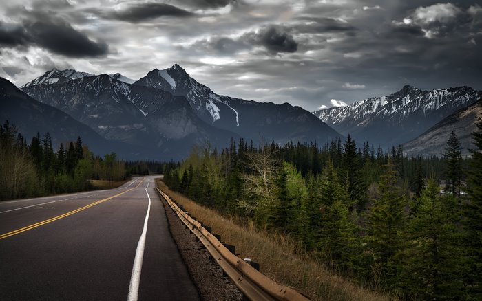 Scenic Road Leading Through Jasper Mountains in Alberta