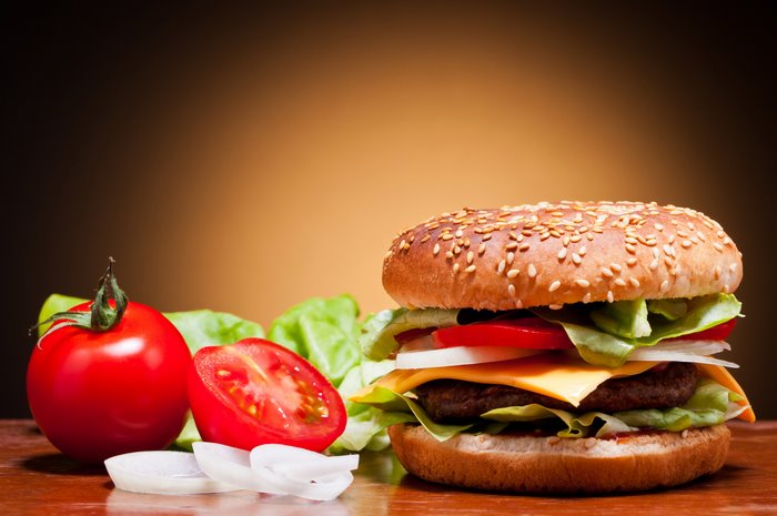 Hamburger with lettuce, tomato, onion, and cheese