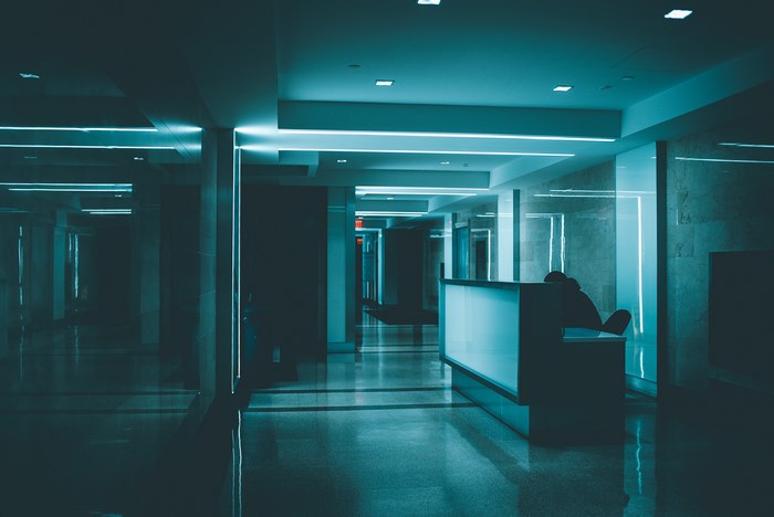 Hallway with reception desk and neon lights