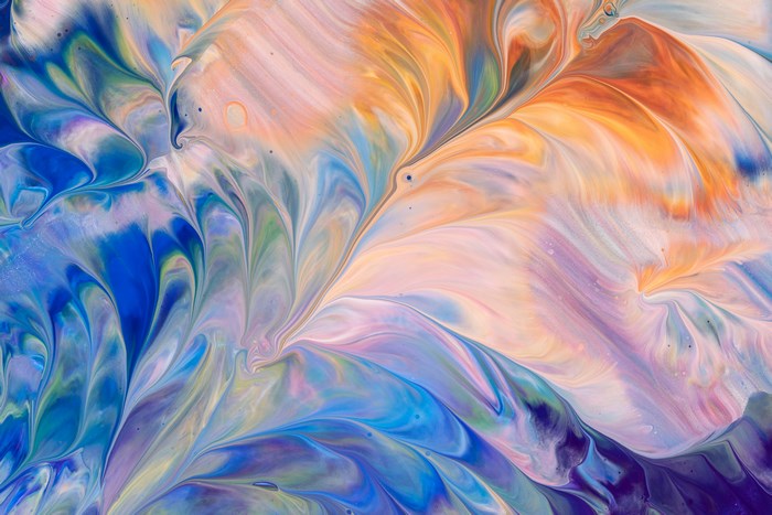 Abstract acrylic paint pour with blue, orange, and purple swirls