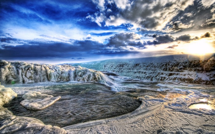 Frozen waterfall under a dramatic sky