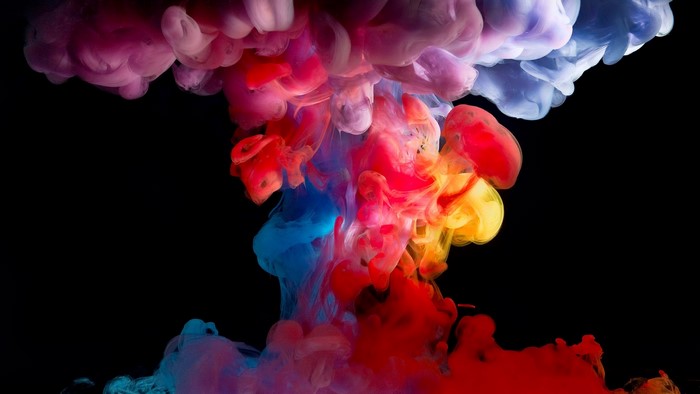 Colorful ink clouds in black background