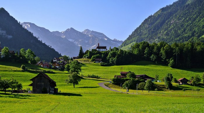Scenic Swiss Countryside with Mountains and Farmhouses