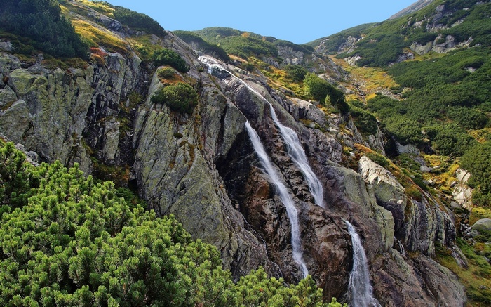 Waterfall cascading down a rocky mountain slope