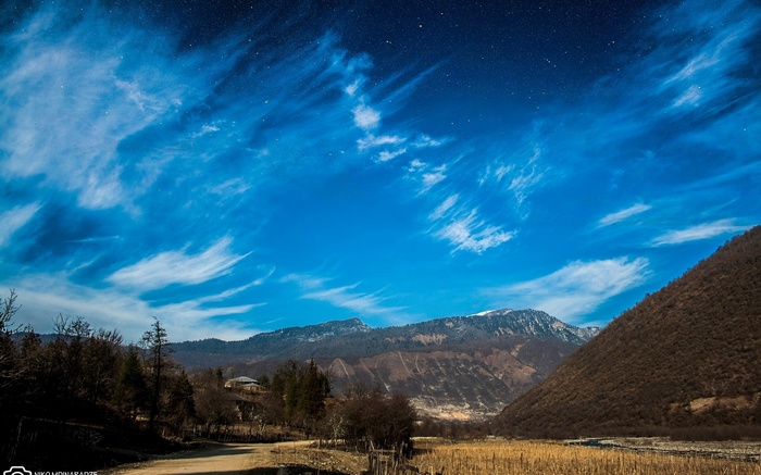 Starry Night Sky Over Mountains and Valley