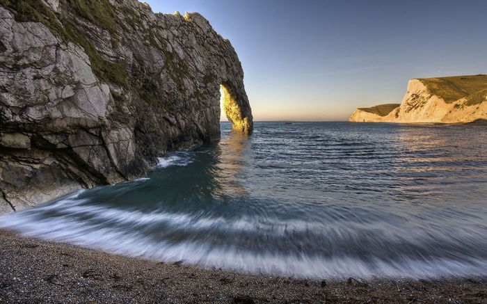 Durdle Door arch rock formation at sunset