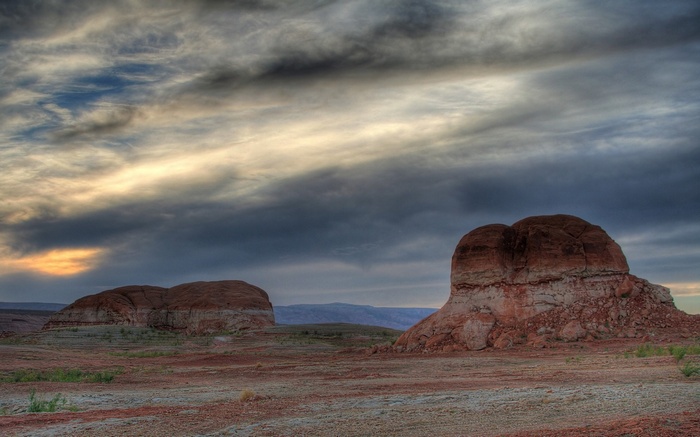 Two rock formations under a cloudy sky