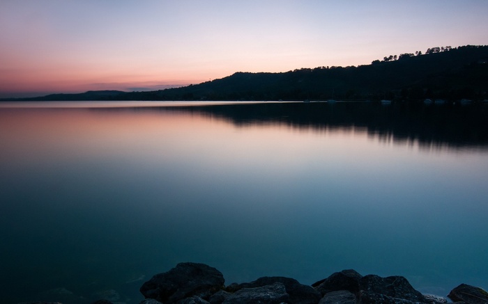 Lake at dusk with rocky shore