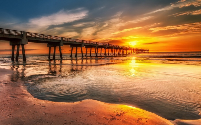 Pier over the ocean at sunset