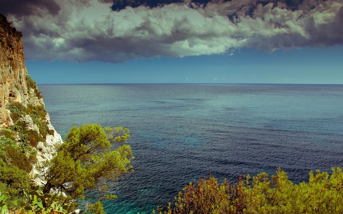 Cliff overlooking the sea with clouds
