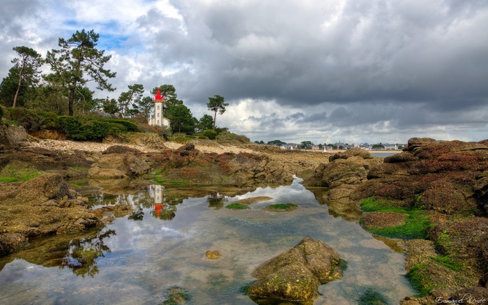 Lighthouse on a rocky shore with tide pools