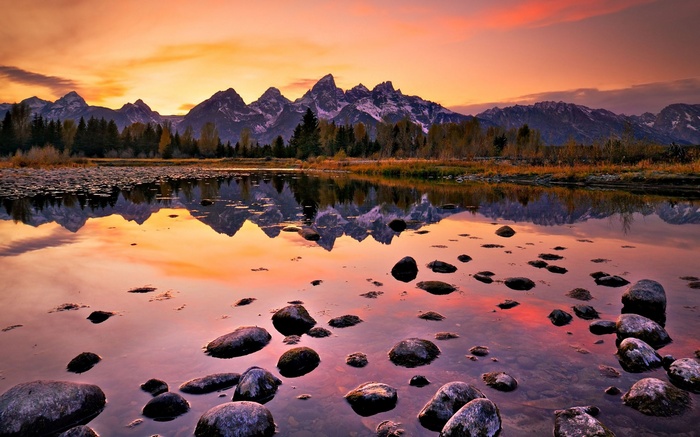Mountains reflected in a lake at sunset
