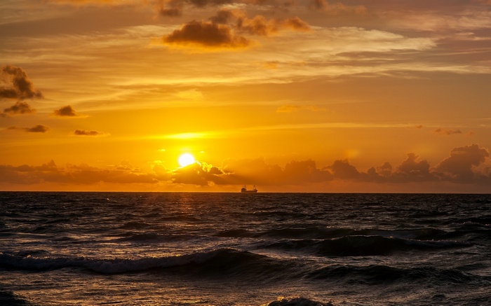 Ship on the ocean at sunset