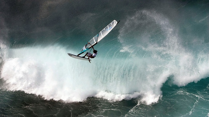 Windsurfer jumps a large wave