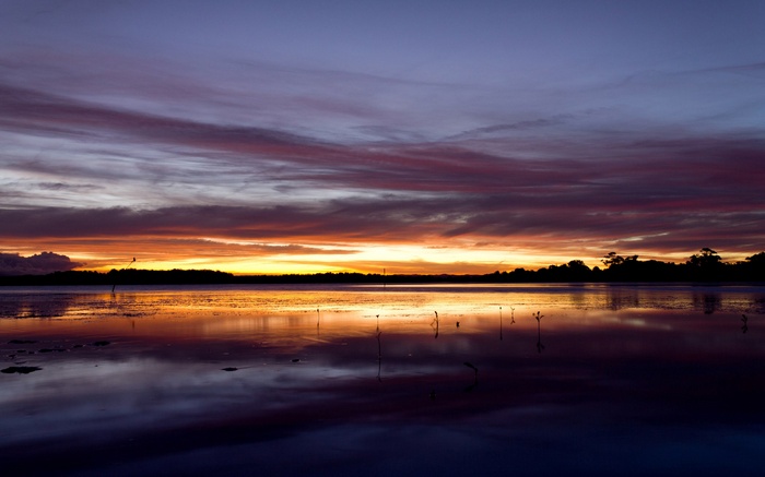 Sunset over a lake with colorful clouds and reflections