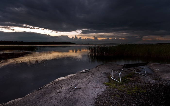 Bench by a lake at sunset