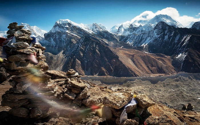 Prayer flags on cairns with Himalayan mountains